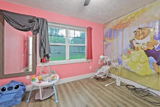 a bedroom with furniture and a window