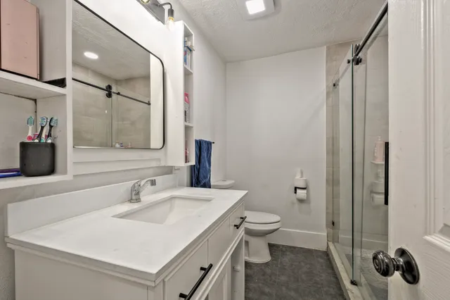 a bathroom with a sink toilet and shower