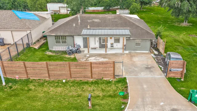 a aerial view of a house with a yard