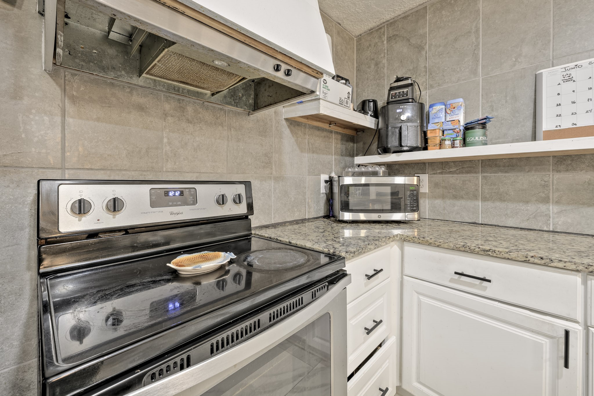 826 Rosewick Street Houston, TX 77015 - Photo 7 of 17 a stove top oven sitting inside of a kitchen