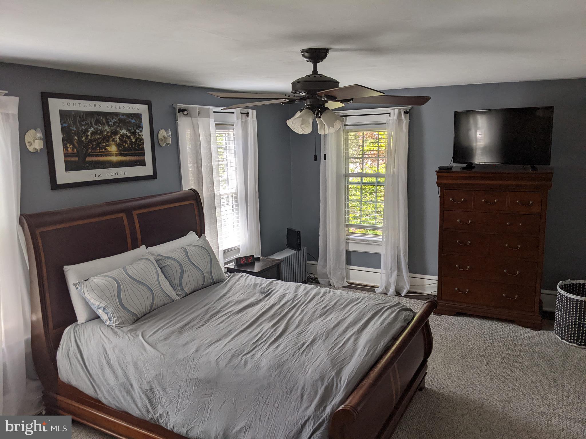 523 Country Club Road York, PA 17403 - Photo 17 of 30 a bedroom with a bed a dresser and a flat screen tv