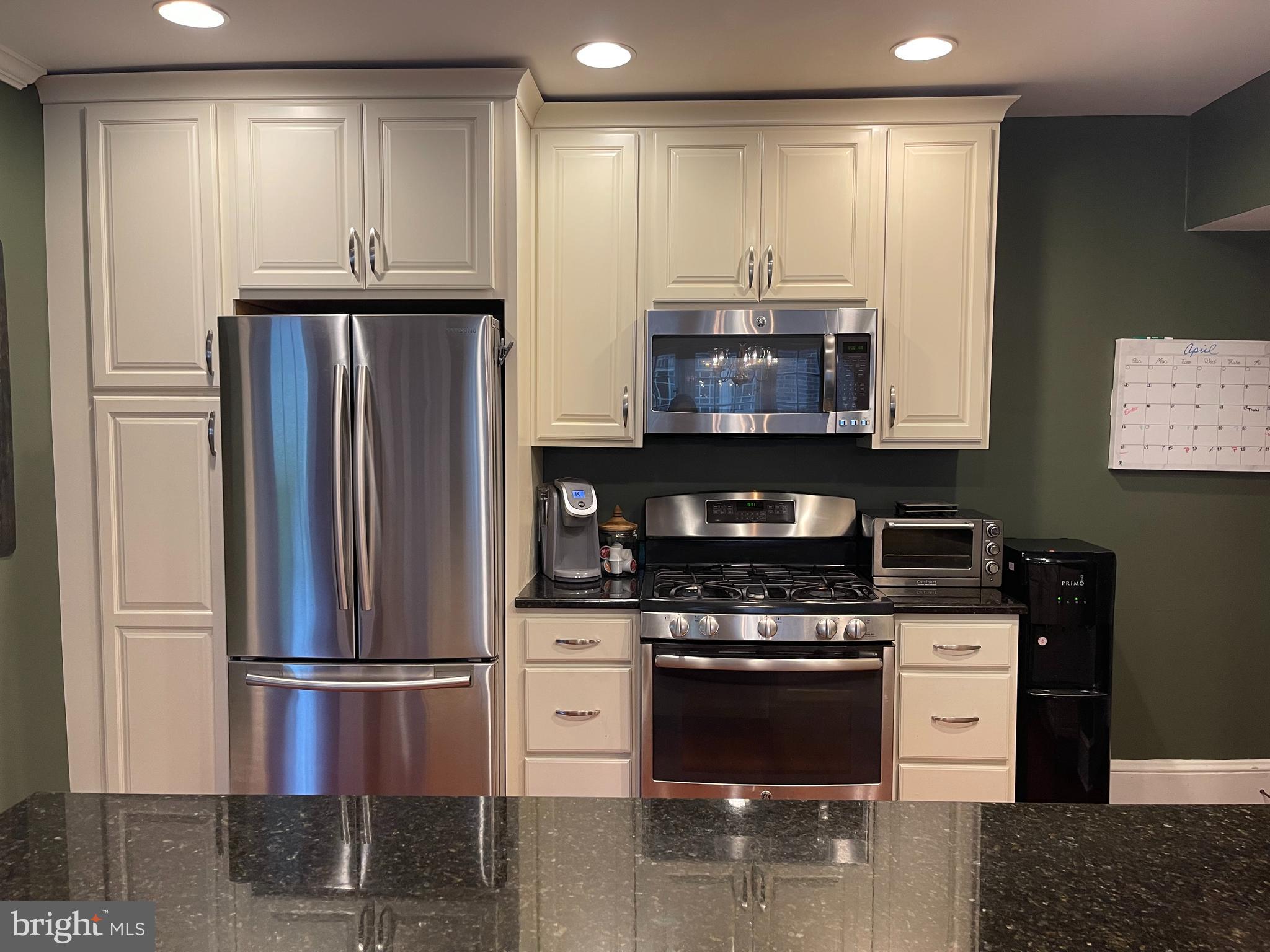 523 Country Club Road York, PA 17403 - Photo 7 of 30 a kitchen with stainless steel appliances granite countertop a stove a refrigerator and a microwave