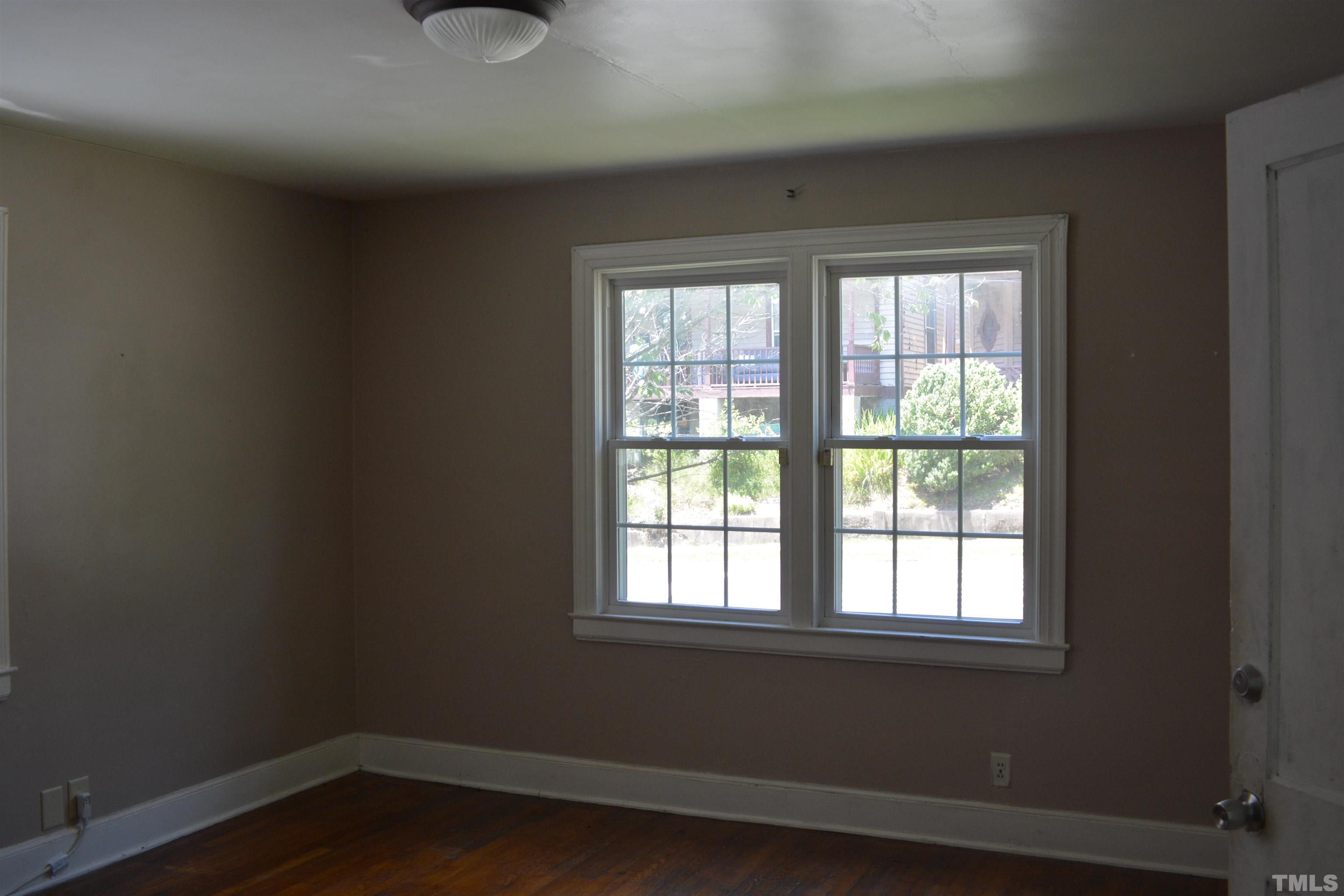 615 Arnette Avenue Durham, NC 27701 - Photo 2 of 12 a view of a room with wooden floor and windows