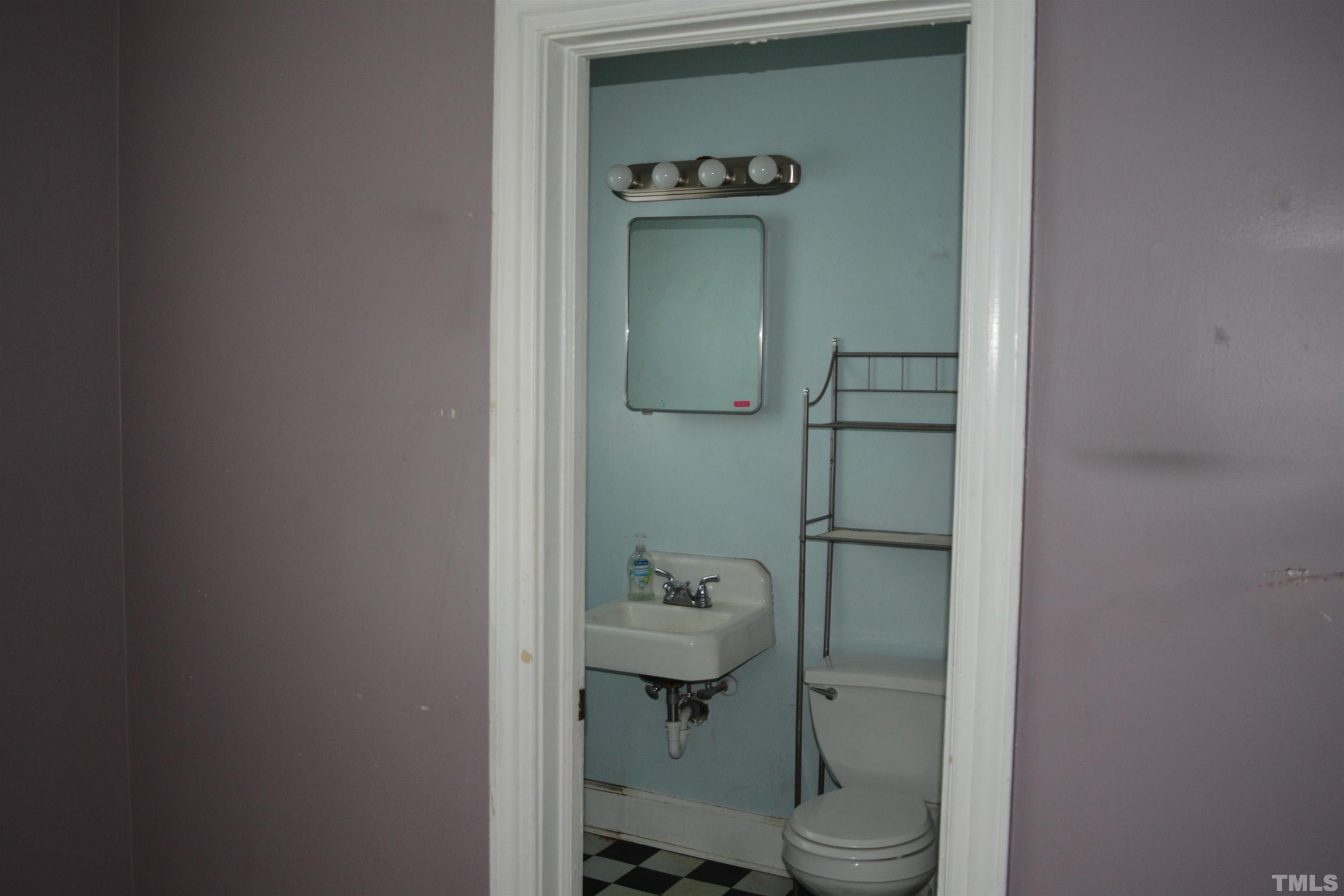 615 Arnette Avenue Durham, NC 27701 - Photo 4 of 12 a bathroom with a granite countertop toilet sink and shower