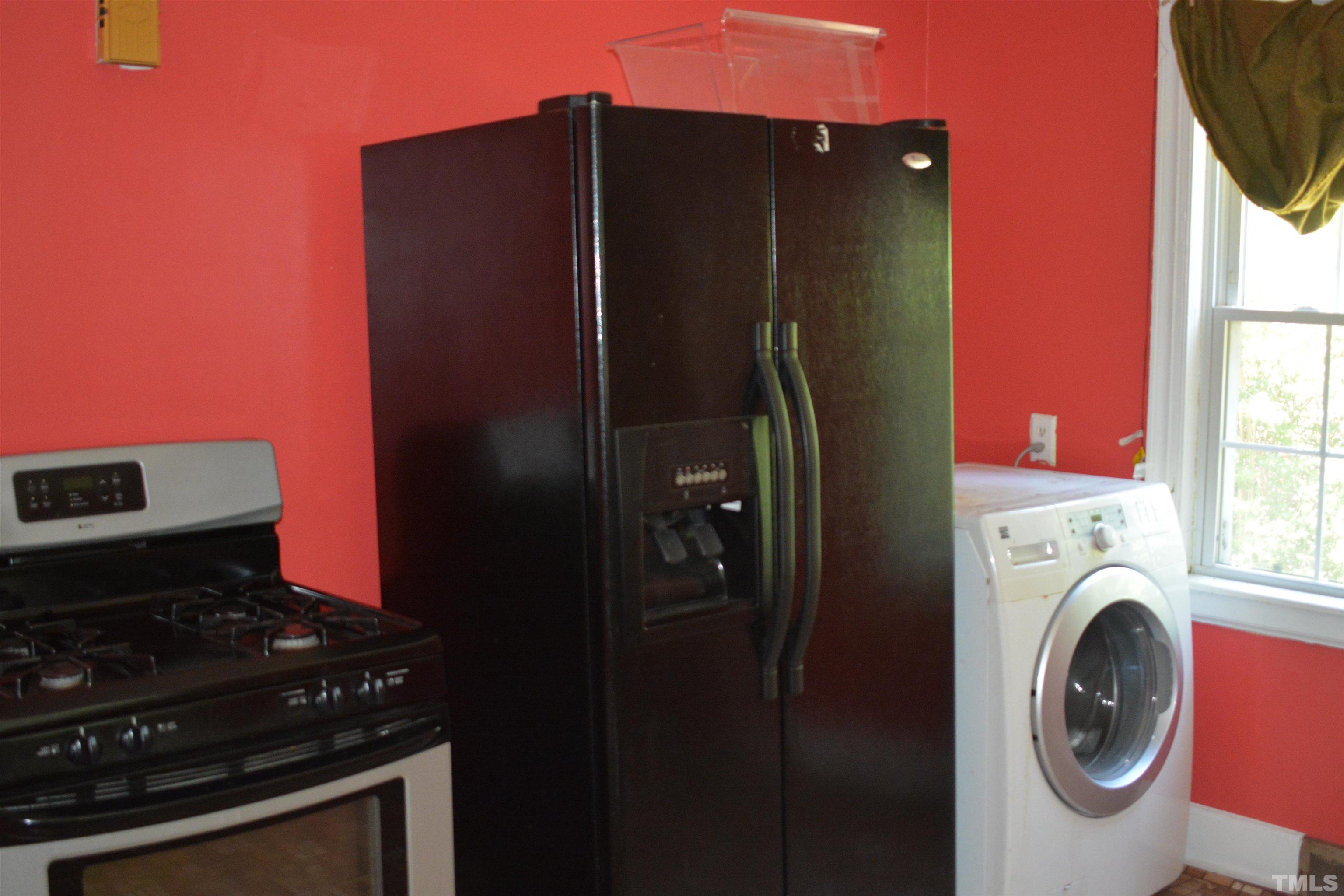 615 Arnette Avenue Durham, NC 27701 - Photo 9 of 12 a kitchen with a refrigerator and a stove top oven