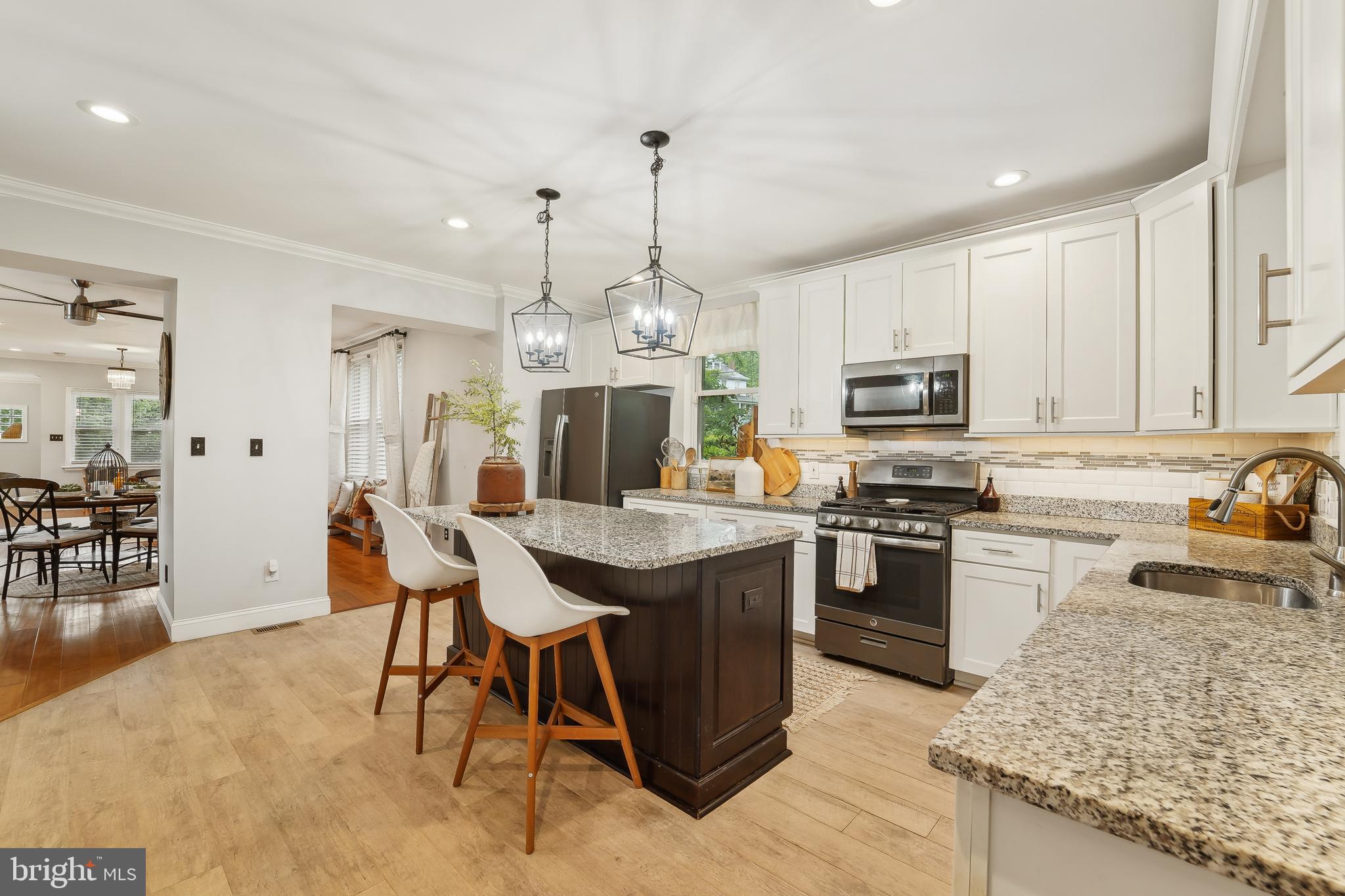 4124 Hamilton Avenue Baltimore, MD 21206 - Photo 16 of 41 a kitchen with stainless steel appliances granite countertop a sink stove and refrigerator
