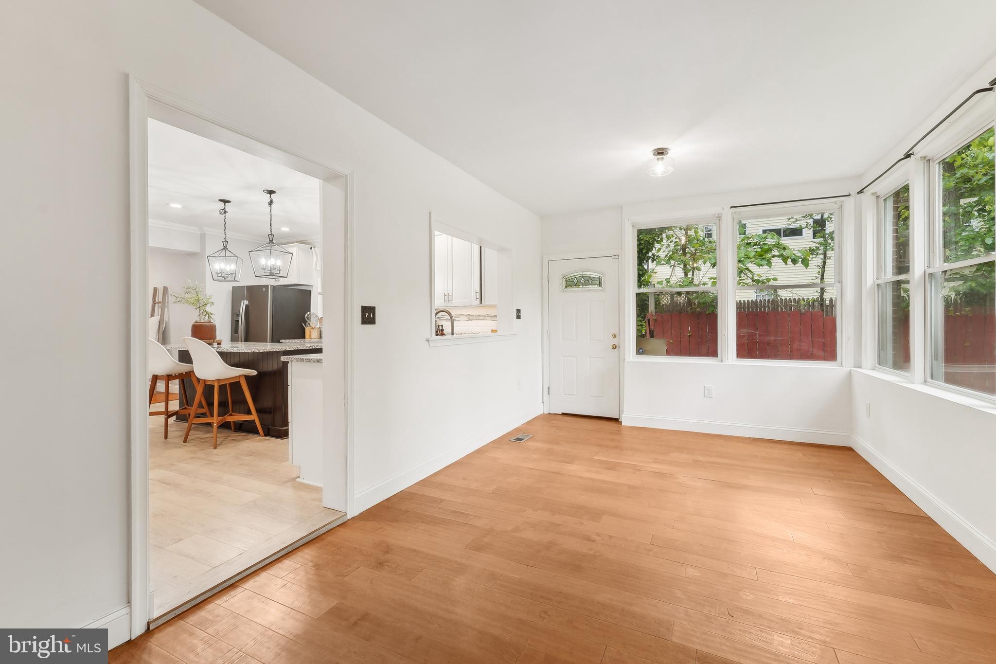 4124 Hamilton Avenue Baltimore, MD 21206 - Photo 21 of 41 a view of empty room with wooden floor and windows