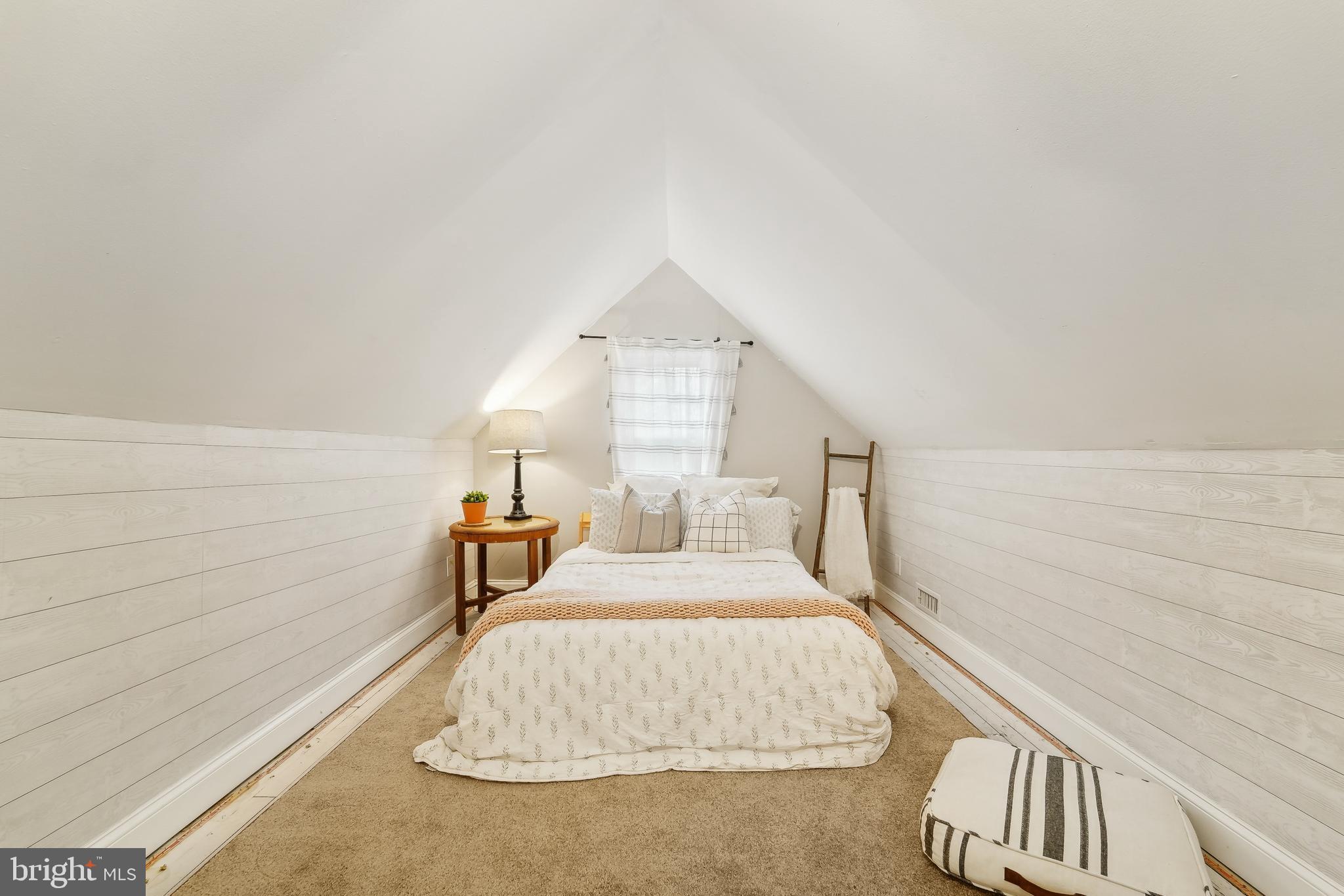 4124 Hamilton Avenue Baltimore, MD 21206 - Photo 30 of 41 a bedroom with a bed and a night stand