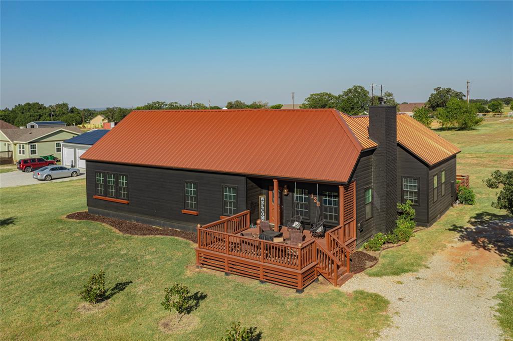 128 McCrae Lane Boyd, TX 76023 - Photo 1 of 1 an outdoor sitting area with a table and chairs