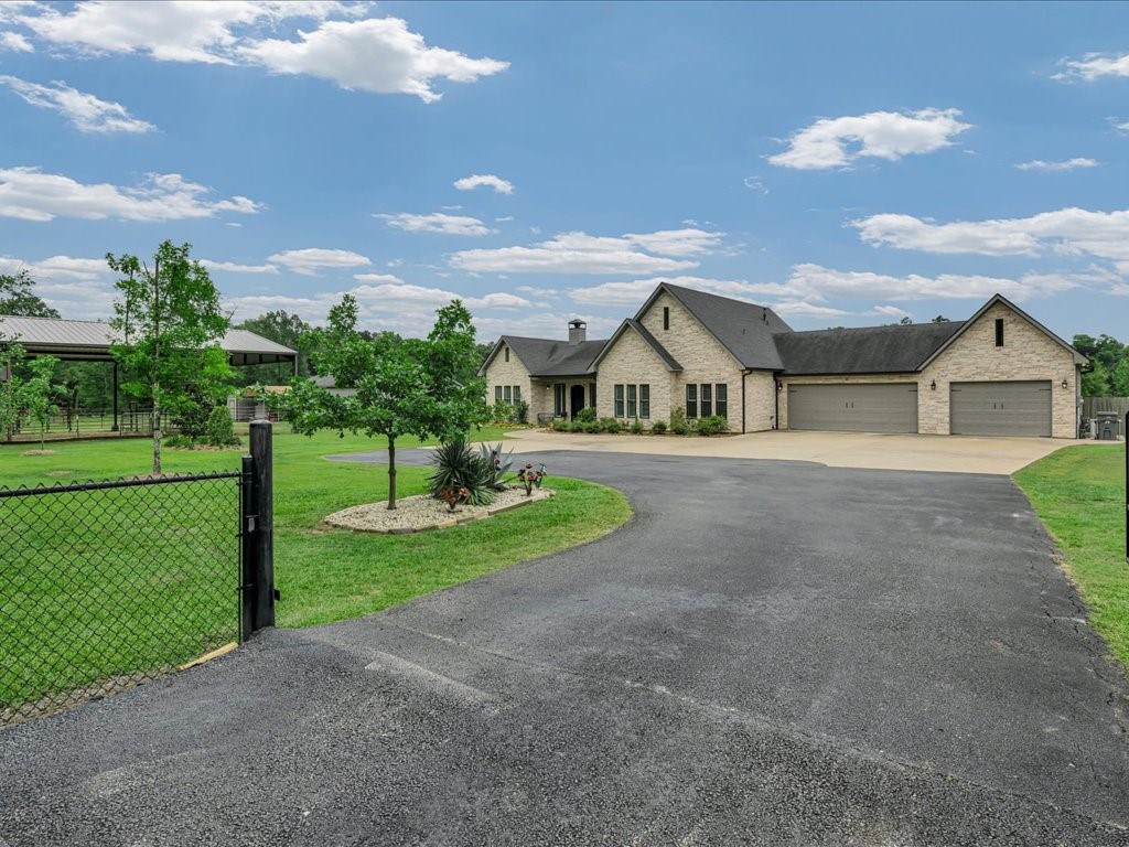 104 Wheeler Road Lufkin, TX 75901 - Photo 3 of 45 a front view of a house with a yard and garage