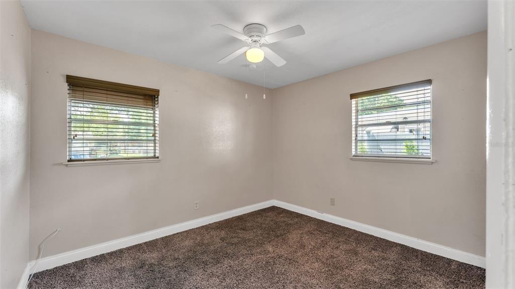 515 Easy Street Bartow, FL 33830 - Photo 12 of 25 an empty room with a window and a ceiling fan