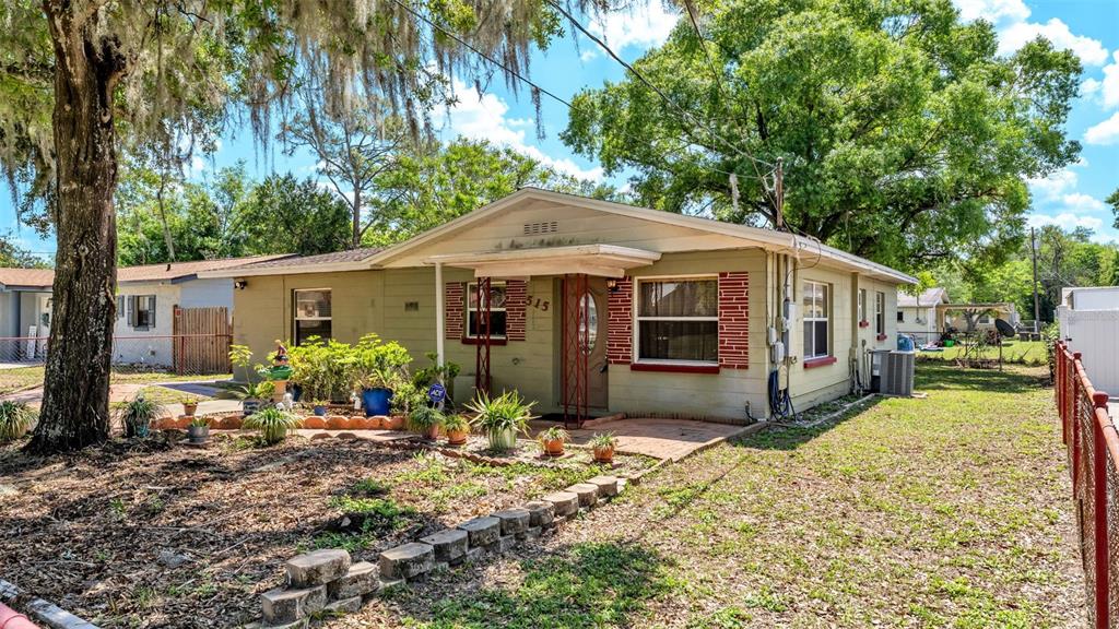 515 Easy Street Bartow, FL 33830 - Photo 2 of 25 a front view of a house with a yard and porch