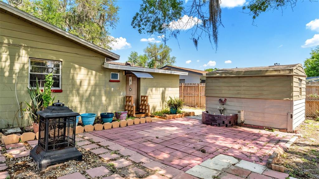 515 Easy Street Bartow, FL 33830 - Photo 24 of 25 a patio with table and chairs and potted plants