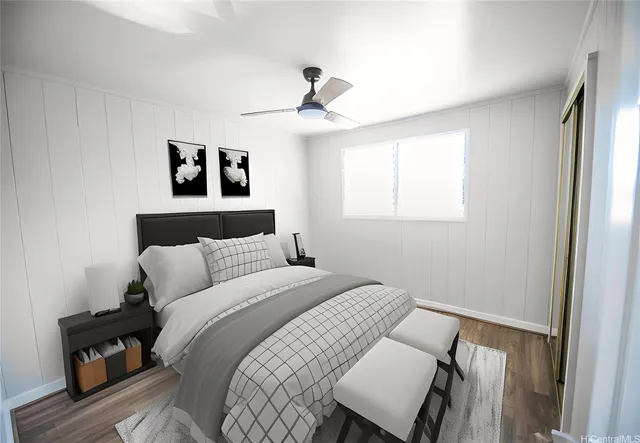 a bedroom with a bed and wooden floor
