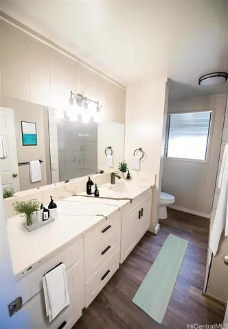 a bathroom with a double vanity sink and mirror