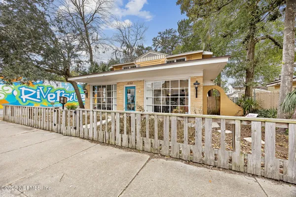 a view of a house with wooden fence