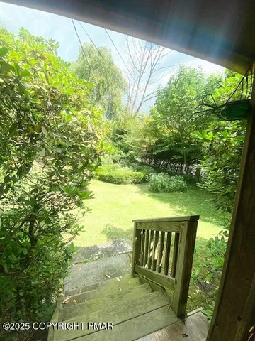 a outdoor dining space with a table and chairs