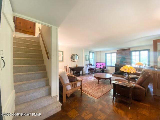 1153 Milford Road Dingmans Ferry, PA 18328 - Photo 33 of 50 a living room with furniture and a potted plant