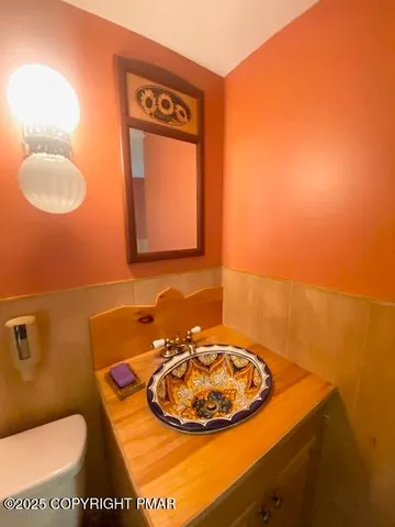 a view of empty room with wooden floor and bathroom