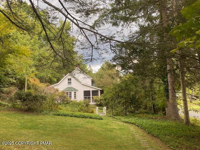 1153 Milford Road Dingmans Ferry, PA 18328 - Photo 9 of 50 a front view of a house with garden
