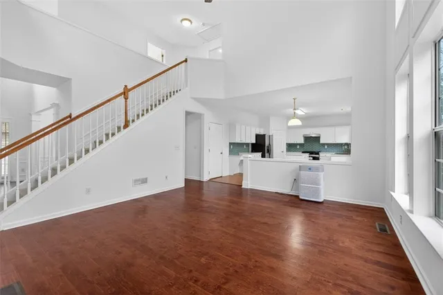 a view of a kitchen with wooden floor and electronic appliances