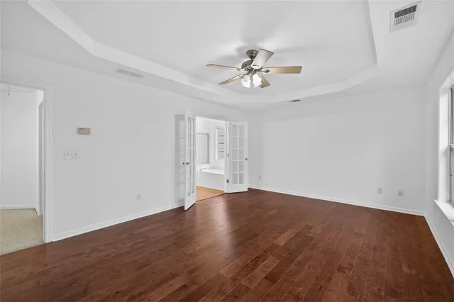 a view of an empty room with wooden floor