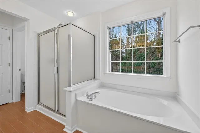 a bathroom with a tub and a window