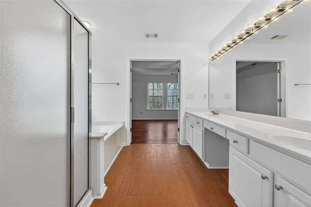 a large white kitchen with a large window