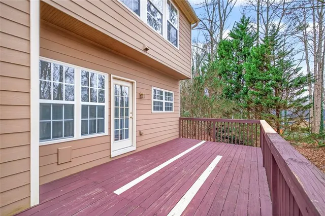 a view of deck with two chairs and wooden floor