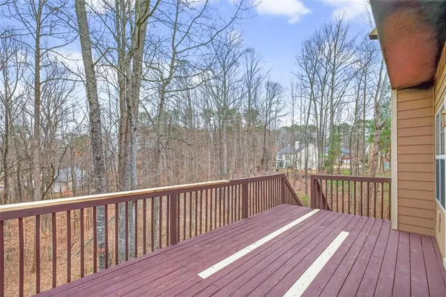 a view of balcony with wooden floor and fence