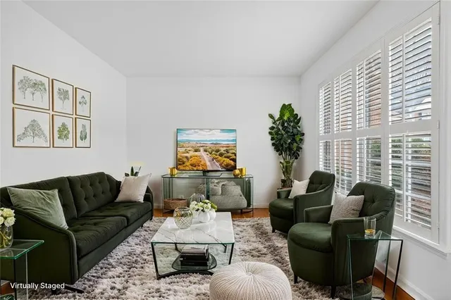 a living room with furniture and a potted plant