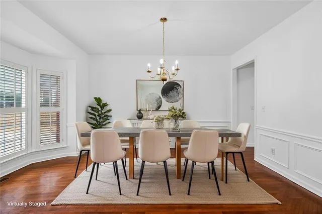 a view of a dining room with furniture wooden floor and chandelier