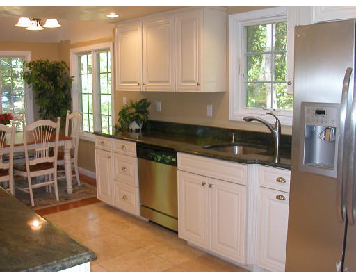 98 Kingland Road Stow, MA 01775 - Photo 3 of 15 a kitchen with stainless steel appliances granite countertop a stove a sink and a granite counter tops