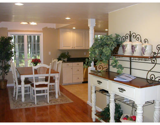 98 Kingland Road Stow, MA 01775 - Photo 4 of 15 a kitchen with stainless steel appliances kitchen island granite countertop a stove a sink and a dining table with wooden floor