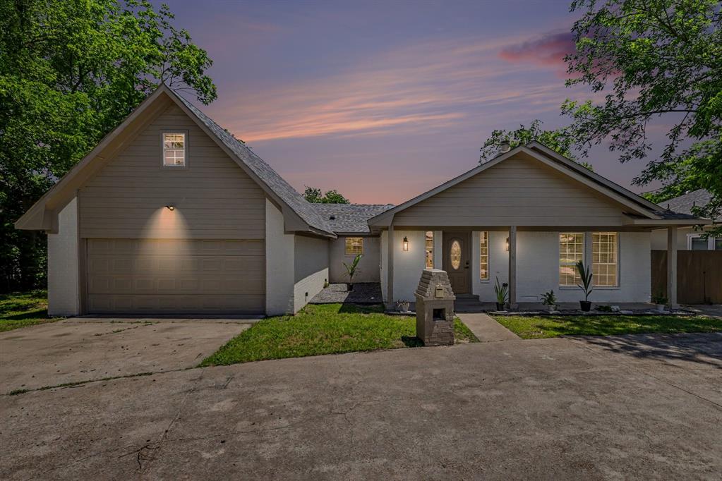 307 Dixon Street Terrell, TX 75160 - Photo 32 of 32 Single-story residence featuring a covered front porch, white stucco exterior, and a prominent front-facing gable with horizontal siding