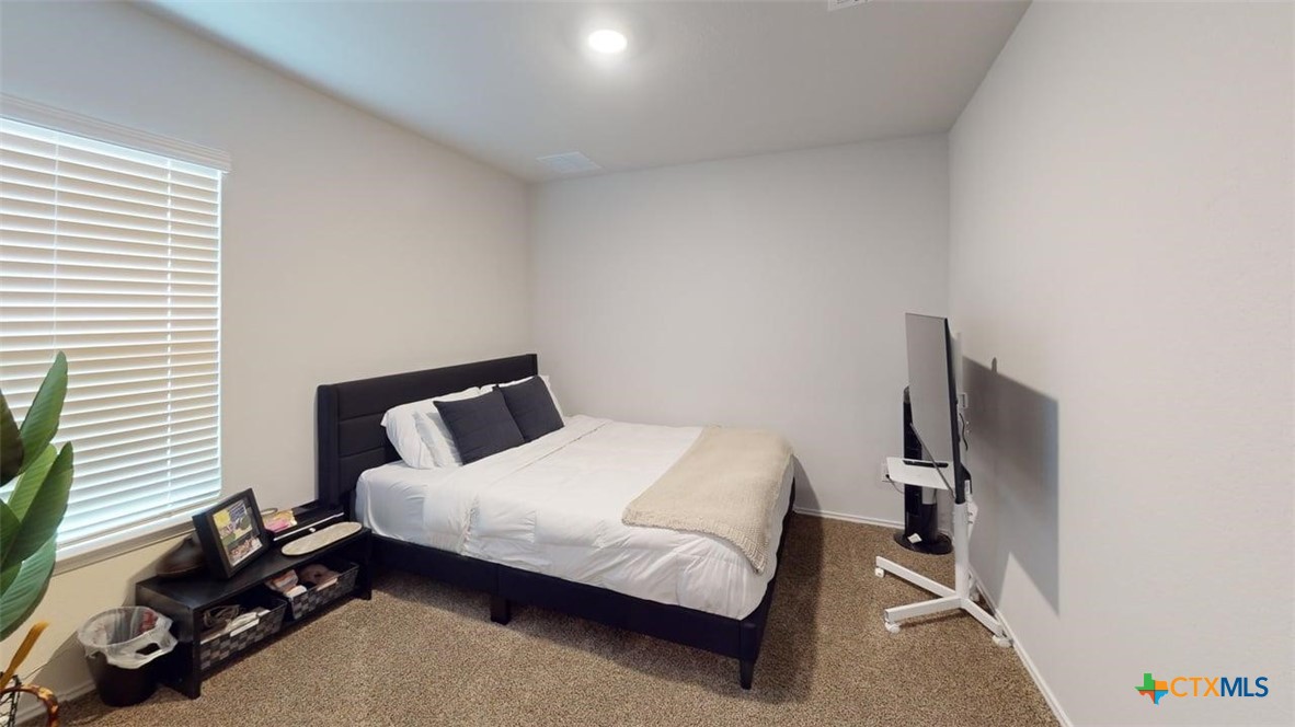 10016 Avendesora Road Killeen, TX 76542 - Photo 13 of 24 a bedroom with a bed and a dresser next to a window