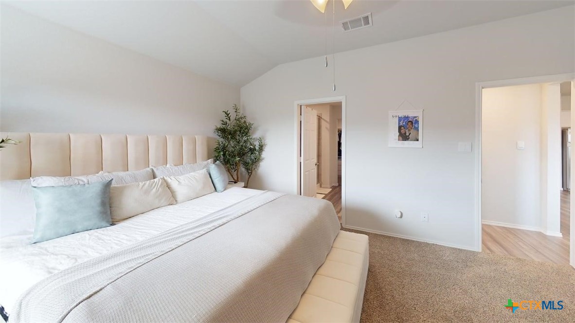 10016 Avendesora Road Killeen, TX 76542 - Photo 19 of 24 a bedroom with a large bed and a couch