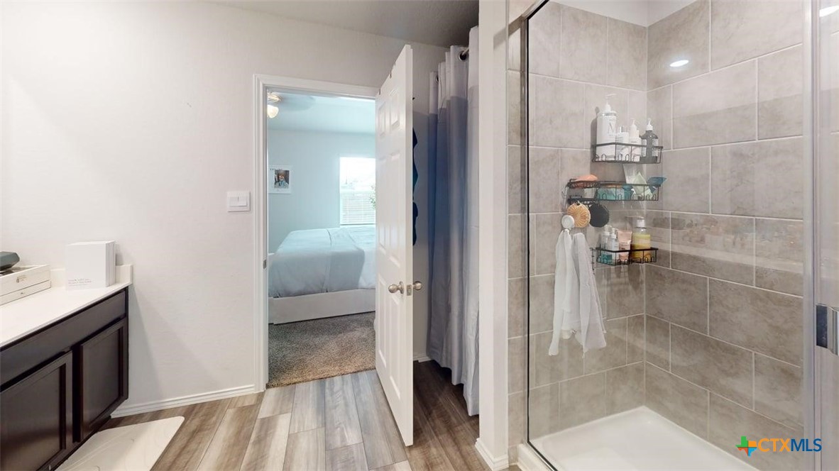 10016 Avendesora Road Killeen, TX 76542 - Photo 8 of 24 a en suite bathroom with a granite countertop shower