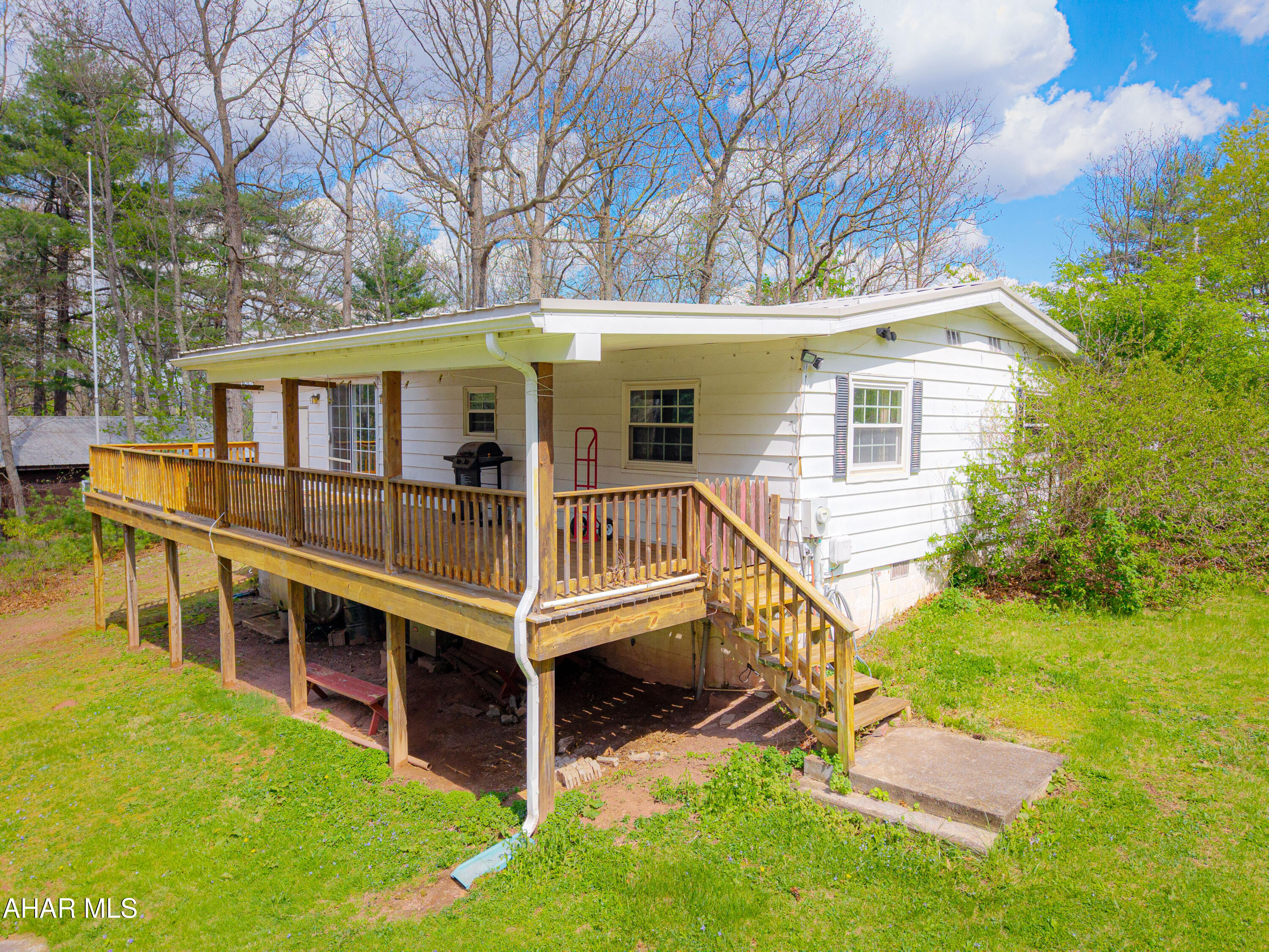 151 Pine Echo Road Everett, PA 15537 - Photo 12 of 51 front view of a house with a yard and deck