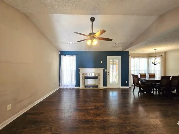 a view of a livingroom with furniture wooden floor and a chandelier