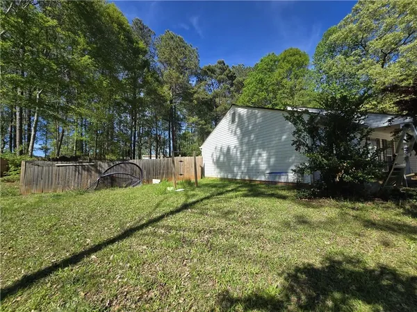 a backyard of a house with a yard and outdoor seating