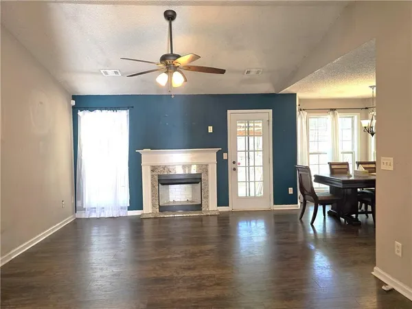 a view of a livingroom with furniture wooden floor and chandelier