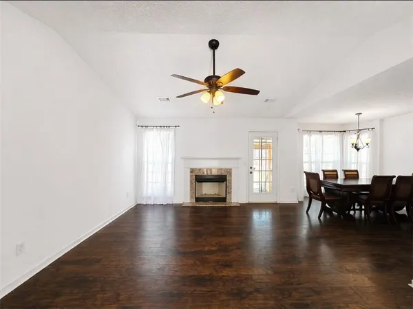 a view of a livingroom with furniture a ceiling fan and fireplace