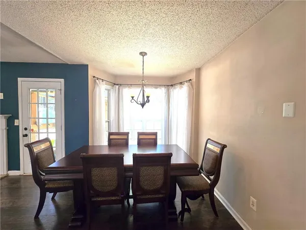 a view of a dining room with furniture and window