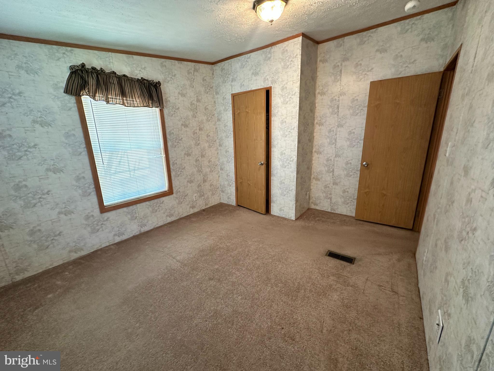 35390 Heron Road Millsboro, DE 19966 - Photo 13 of 25 an empty room with windows and closet