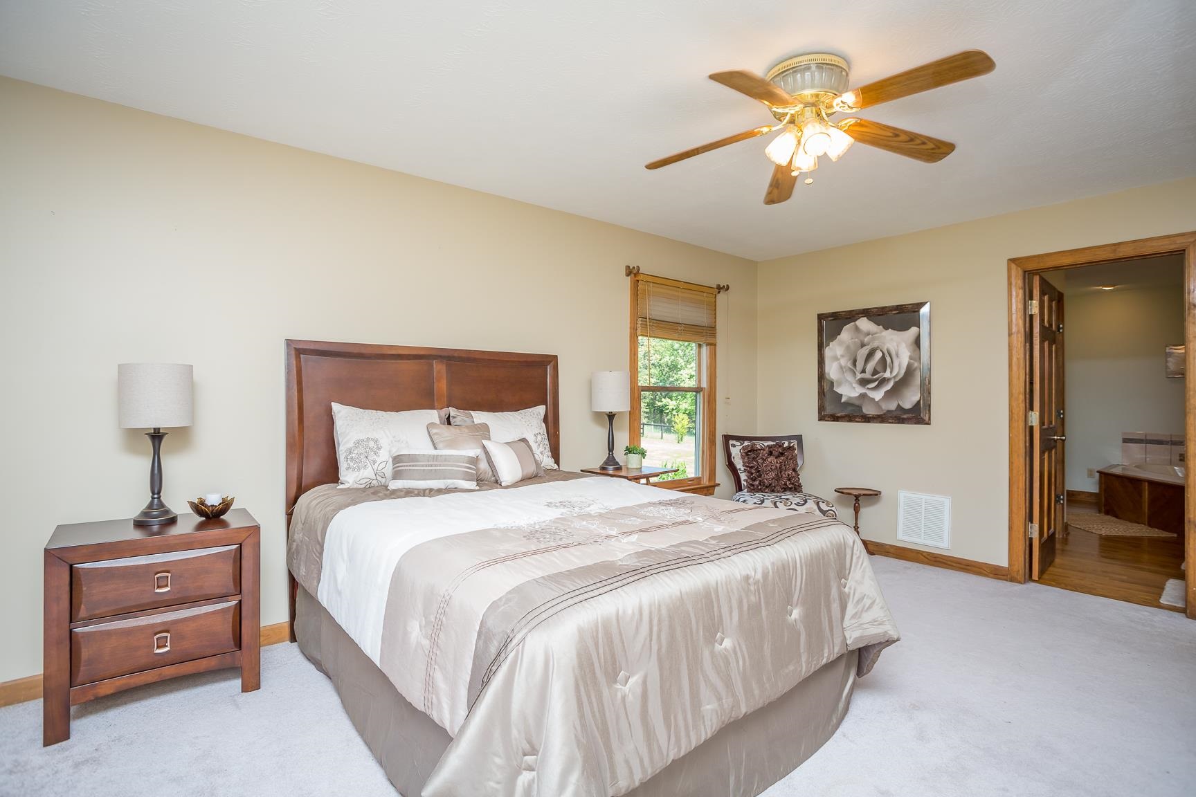 8455 East Timber Ridge Road Mount Crawford, VA 22841 - Photo 31 of 62 a bedroom with a bed and a chandelier