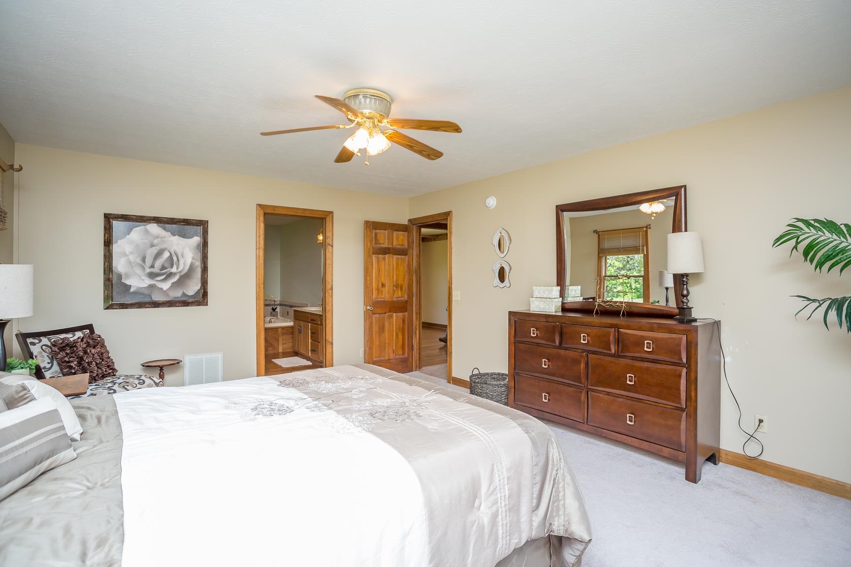 8455 East Timber Ridge Road Mount Crawford, VA 22841 - Photo 32 of 62 a bedroom with a bed and a chandelier