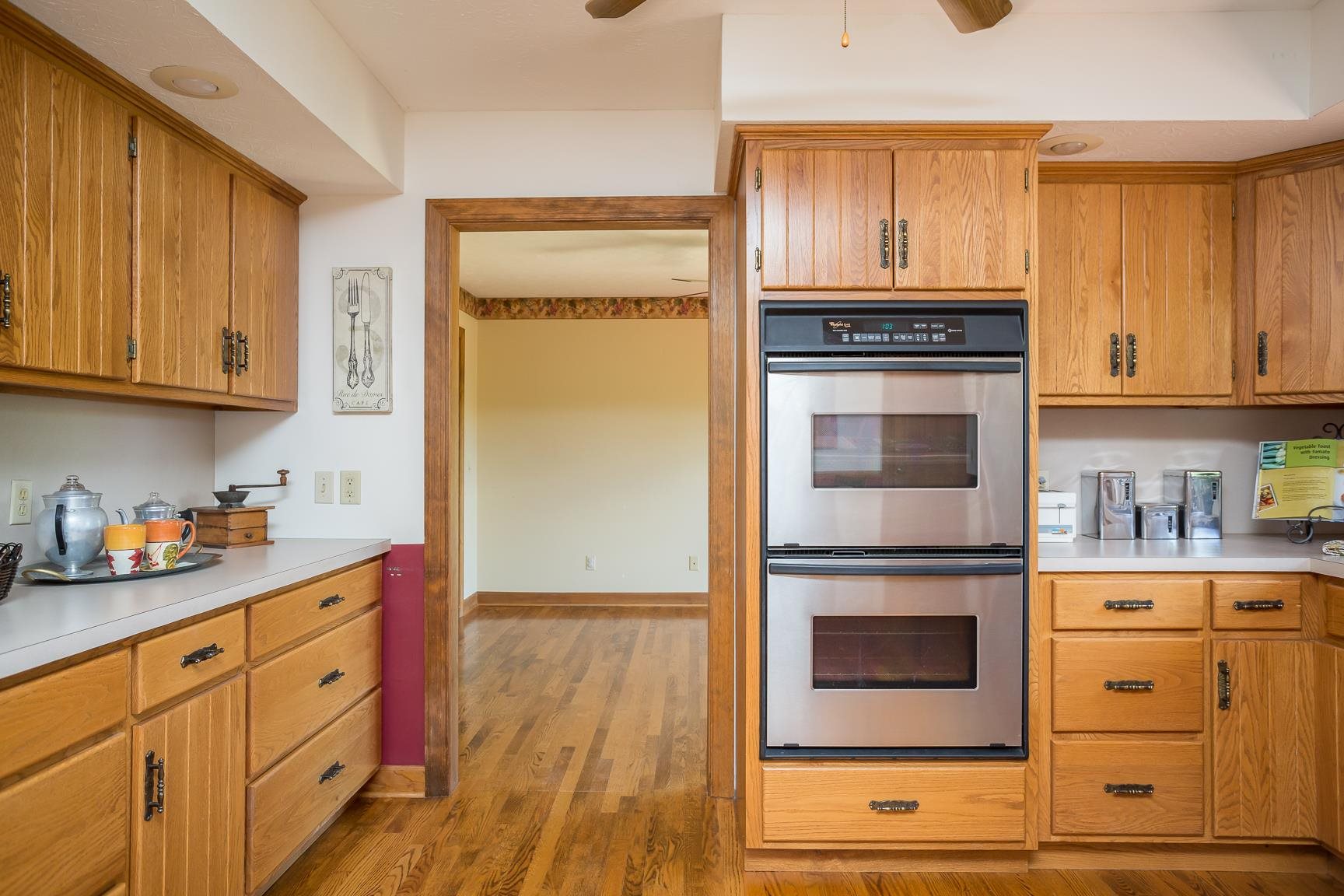 8455 East Timber Ridge Road Mount Crawford, VA 22841 - Photo 39 of 62 a kitchen with stainless steel appliances white cabinets and a stove top oven