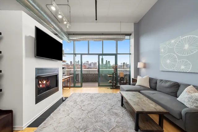 a living room with furniture a flat screen tv and a fireplace