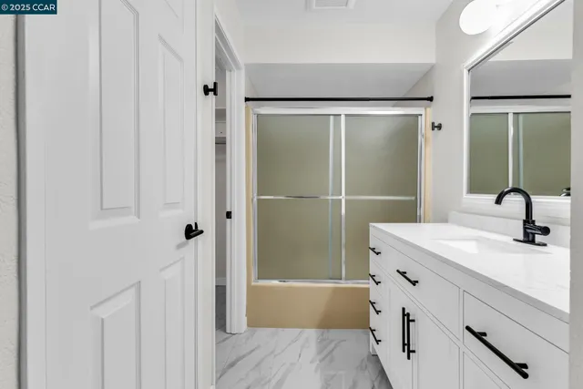 a bathroom with a shower and a sink